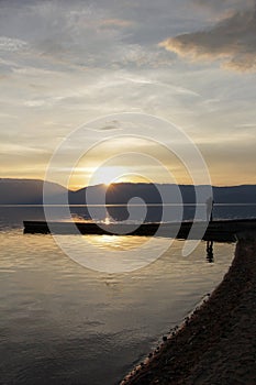 Magnificent scenery .man picturing sunset over lake prespa in macedonia