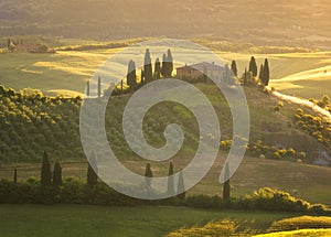 Magnificent spring landscape at sunrise.Beautiful view of typical tuscan farm house, green wave hills.