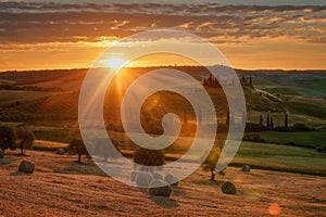 Magnificent spring landscape at sunrise.Beautiful view of typical tuscan farm house, green wave hills.