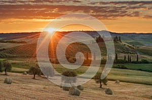 Magnificent spring landscape at sunrise.Beautiful view of typical tuscan farm house, green wave hills.