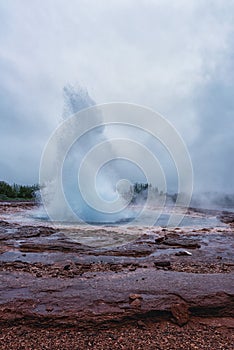 Magnificent Strokkur Geyser erupts the fountain of water, Haukadalur geothermal area, Iceland