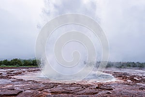 Magnificent Strokkur Geyser erupts the fountain of water, Haukadalur geothermal area, Iceland