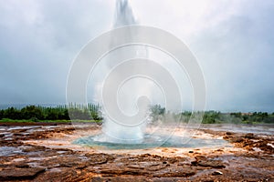 Magnificent Strokkur Geyser erupts the fountain of water, Haukadalur geothermal area, Iceland