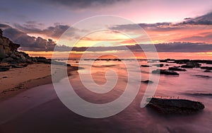 Magnificent sunrise high tide at Bateau Bay rockshelf