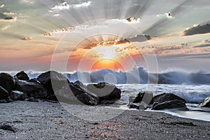 Magnificent sunrise and powerful seawaves by a sandy beach