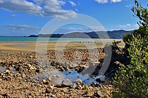 Magnificent Tinline Bay in New Zealand with horse rider on the beach