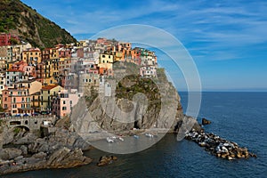 Magnificent daily view of the Manarola village in a sunny summer day.