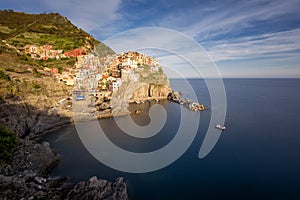 Magnificent daily view of the Manarola village in a sunny summer day.
