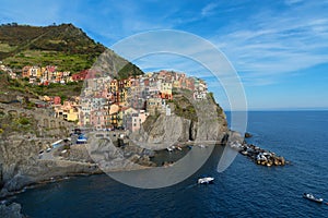 Magnificent daily view of the Manarola village in a sunny summer day.