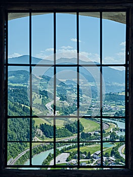 Magnificent view of the Salzach River and surroundings through a barred window from the medieval Hohenwerfen Castle in Austria