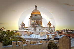 A magnificent view of St. Isaac`s Cathedral at sunset from the rooftops. Top view of the city of Petersburg. Beautiful sunset