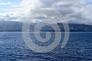 Magnificent views from the high seas with a beautiful enraged sky as a background the island of La Gomera. April 15, 2019. La