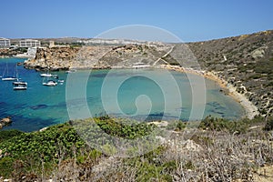 Magnificent views of Riviera Beach and the small watchtower Ghajn Tuffieha Tower, limits of Mgarr, Mellieha, Malta.