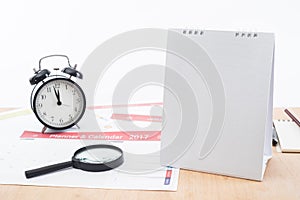 Magnifier and clock with business Calender Planner 2017 on desk office.