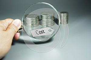 Magnifier, Cost Tag, and Stack of Coins in the backdround