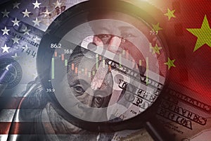 Magnifier glass focus on USD dollar and Yuan banknote with USA and China flag .It is symbol of economic tariffs trade war ,tax