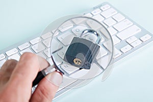 Magnifier looks at the lock on the keyboard. security search concept