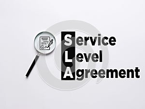 Magnifier magnifies the agreement contract symbol with the word SLA service level agreement