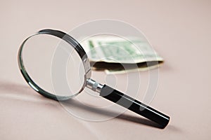 magnifier and money on white background