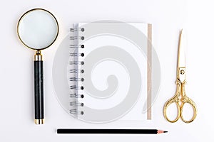 Magnifier, notepad and scissors