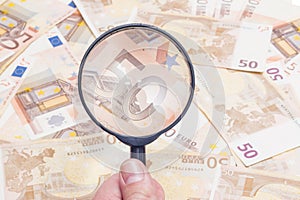 Magnifier over fifty euro notes