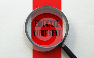 Magnifier with text Educate Yourself on the white and red background
