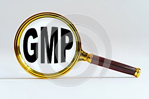 Magnifier on a white background, inside the text is written - GMP