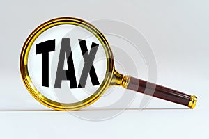 Magnifier on a white background, inside the text is written - TAX