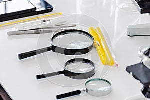 Magnifiers, thermometer in scientific laboratories