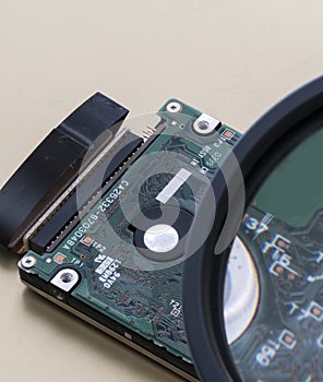 Magnifing glass is enlarging specific areas on a integrated circuit oard fused in  computers