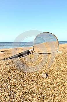 Magnify Glass on the Sand Beach