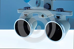 Magnifying binocular glasses close-up. Dental instruments in the