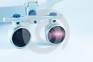 Magnifying binocular glasses close-up. Dental instruments in the