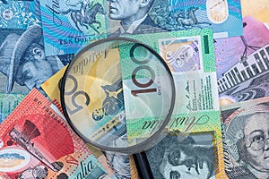 Magnifying glass on australian dollar banknote as background