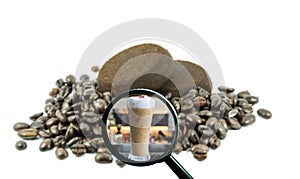 Magnifying glass with background of roasted coffee beans to be i