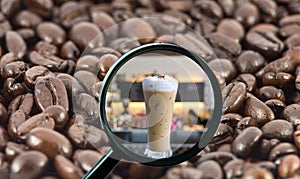 Magnifying glass with background of roasted coffee beans to be i