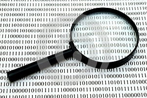 Magnifying glass and binary code