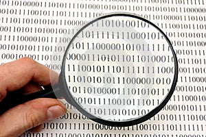 Magnifying glass and binary code