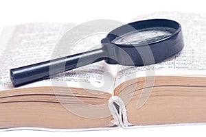 Magnifying glass on a book.