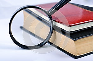 Magnifying glass with books