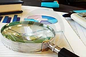 Magnifying glass on business documents. Accounting and financial audit.