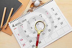 Magnifying glass and calendar,Concept in business and meetings