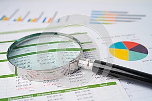 Magnifying glass on charts graphs paper. Financial development, Banking Account, Statistics, Investment Analytic research data