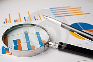 Magnifying glass on charts graphs paper. Financial development, Banking Account, Statistics, Investment Analytic research data