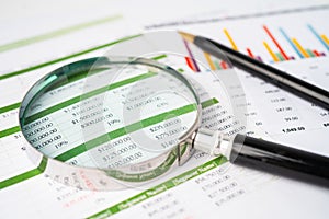 Magnifying glass on charts graphs paper. Financial development, Banking Account, Statistics, Investment Analytic research data