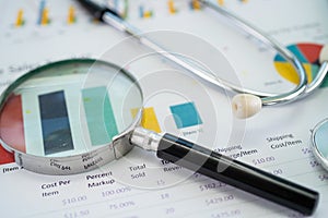 Magnifying glass on charts graphs paper. Financial development, Banking Account, Statistics, Investment Analytic research data