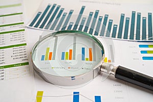 Magnifying glass on charts graphs paper. Financial development, Banking Account, Statistics, Investment Analytic research data