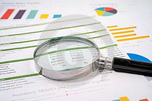 Magnifying glass on charts graphs paper. Financial development, Banking Account, Statistics, Investment Analytic research data