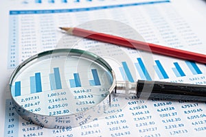 Magnifying glass on charts graphs paper. Financial development, Banking Account, Statistics, Investment Analytic research data