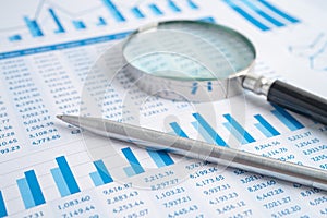 Magnifying glass on charts graphs paper. Financial development, Banking Account, Statistics, Investment Analytic research data